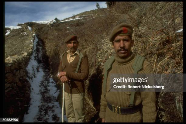 Soldiers on patrol in trenches at army post in disputed Kashmir border area.