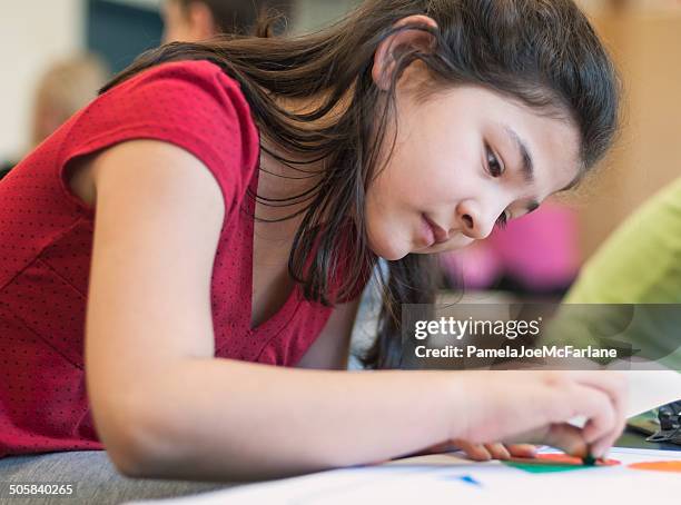 serious young pan-asian girl drawing in art class - pastel crayon stock pictures, royalty-free photos & images