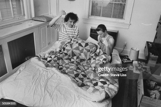 Astronomer/computer mgr. Cliff Stoll sitting in bed w. His wife Martha Matthews, helping her sew a patchwork quilt at home; prob. Baltimore.