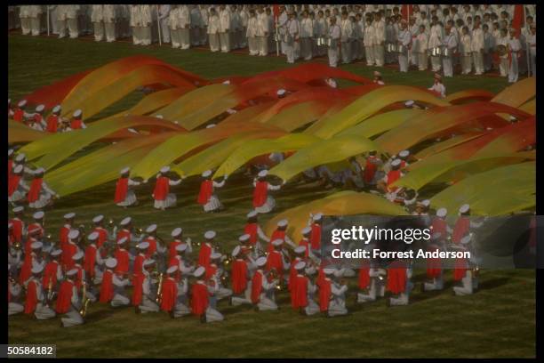 Performers doing number during dress rehearsal for Asian Games opening ceremony, w. Band playing as others create patterns w. Colorful...