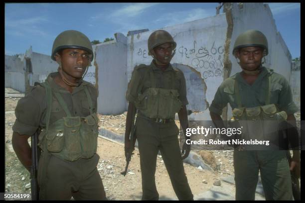 Soldiers standing by ruins as Colombo govt. Forces battle Liberation Tigers of Tamil Eelam rebels for control of besieged Jaffna Fort.