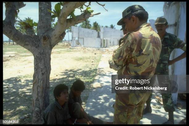 Troops w. 2 handcuffed boys as govt. Forces battle Liberation Tigers of Tamil Eelam for control of besieged Jaffna Fort.