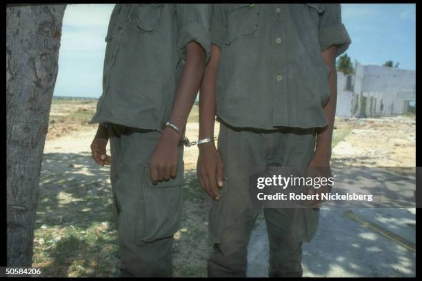 Handcuffed boys in custody as govt. Forces battle Liberation Tigers of Tamil Eelam for control of besieged Jaffna Fort.