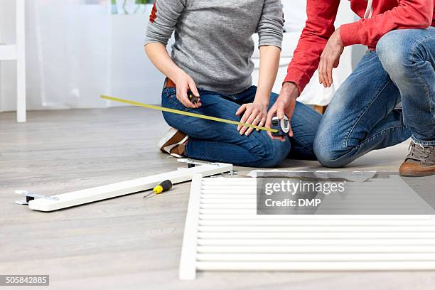 couple at home with tools assembling baby crib - furniture instructions stock pictures, royalty-free photos & images