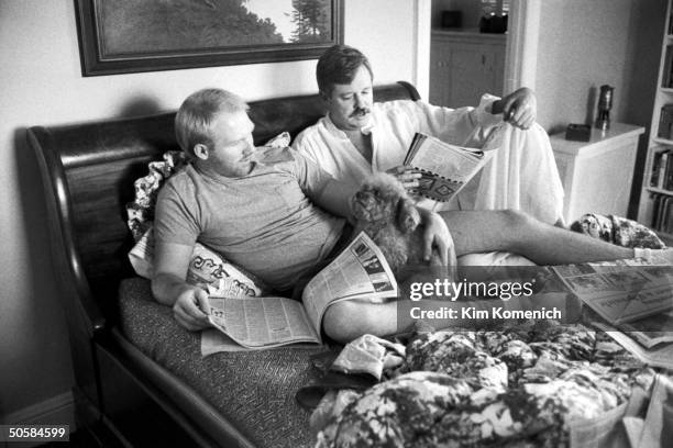 Gay writer Armistead Maupin reading on bed w. Lover Terry Anderson , HIV-positive whose AIDS is under control w. AZT, w. Their dog, Willie.