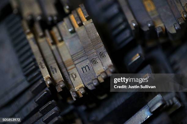 Letter molds called matrices that are used to form metal type slugs in a vintage hot metal Linotype typesetting machine sit in a tray at the Saguache...