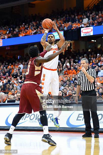 Michael Gbinije of the Syracuse Orange shoots the ball as Eli Carter of the Boston College Eagles defends during the first half at the Carrier Dome...