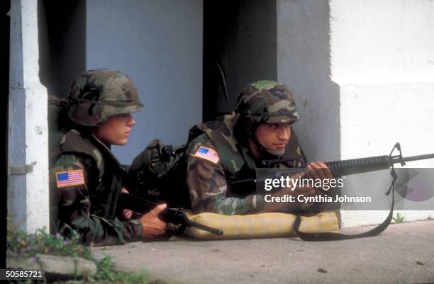 Two US soldiers on balcony of bldg. After US invasion & occupation to unseat ldr. Gen. Manuel Antonio Noriega.