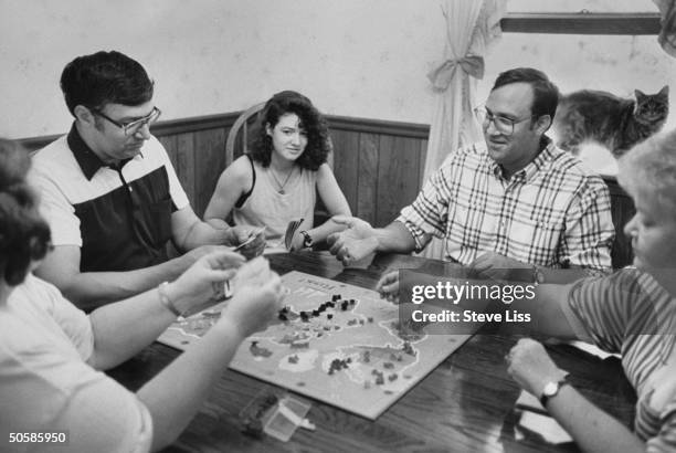 Wrongly accused Malcolm Emory, now a physics student playing game of Risk w. Brother Ernest , niece Kristy & others at Ernest's home after he was...