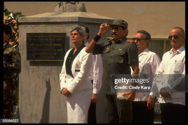 Pres. Violeta Barrios de Chamorro standing w. Saluting Def. Min. Gen. Humberto Ortega as he leads Army in pledging allegiance to her govt.