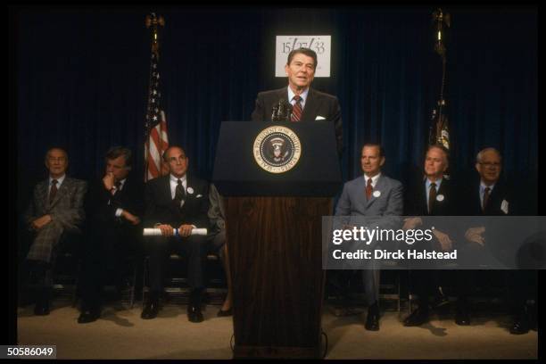 Pres. Reagan addressing tax reform mtg., w. Senators Simpson, Long, Packwood, Secy. Baker, unident., Kennedy & Thurmond in bkgrd.