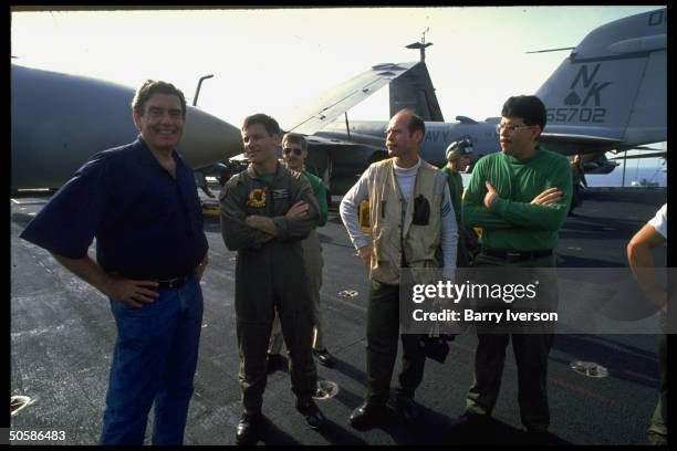 News anchorman Dan Rather w. Crewmen on flight deck of USS Independence, covering gulf crisis spawned by Iraqi invasion of Kuwait .