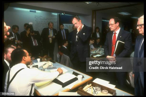 Pres. Bush visiting office of emergency coordination agency FEMA, questioning staffers on response to earthquake.