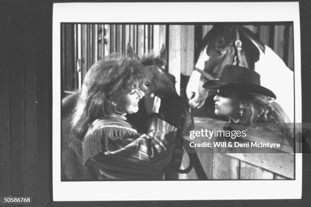 Wynonna Judd, daughter of mother-daughter C/W duo , joking in stable w. Horses w. Mother Naomi, suffering from chronic hepatitis. At their farm nr...