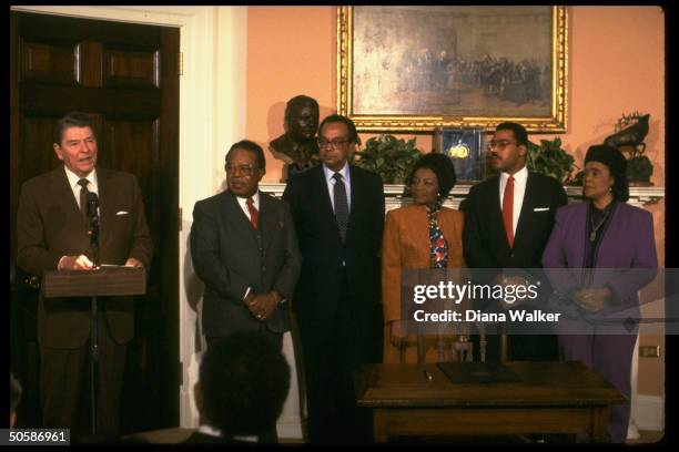 Coretta Scott King, son Dexter, sister-in-law Christine Farris, Pierce, Abernathy & President Reagan pose for photographs after proclamation of the...