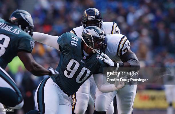Cory Simon of the Philadelphia Eagles fights against the defense of the San Diego Chargers during the game at Veterans Stadium in Philadelphia,...