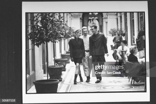 Fashion designer Jean-Paul Gaultier w. Models showing off his designs incl. Male in double-breasted suit w. Long polka dot shorts worn over the pants...