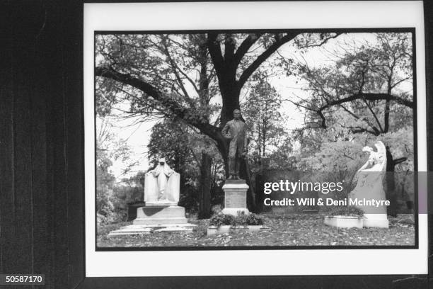 Grave of Jefferson Davis. Pres. Of the Confederacy, w. Statue of him atop headstone amongst graves of other family members. Hollywood Cemetery.