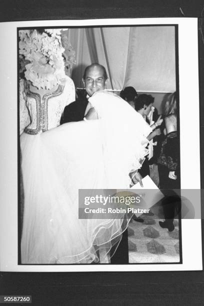 Fashion designer Oscar de la Renta holding white tulle skirt of one of his gowns, at 7th Ave on Sale AIDS benefit.