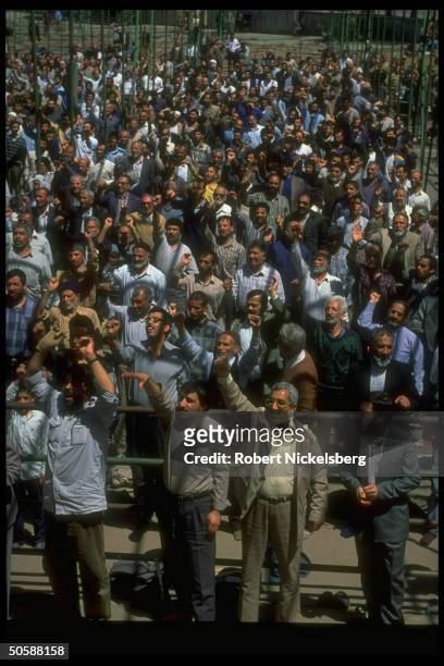 Emoting crowd shouting down w. USA, down w. Israel, attending Fri. Moslem prayer service, held outside.
