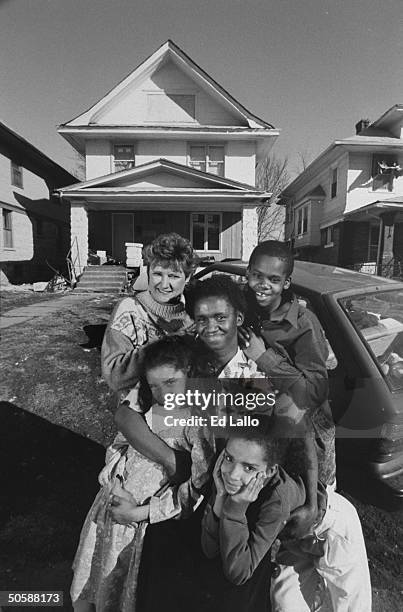 Homeless mother Rosemary Pritchett w. Her kids Jeremiah, Stephanie & Natasha, posing w. Cheryl Wood, who gratefully expedited the renovation of...