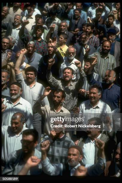 Emoting, fist raising crowd shouting down w. USA, down w. Israel, attending Fri. Moslem prayer service, held outside .