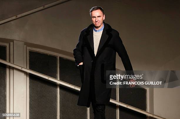 Belgian designer Raf Simons acknowledges the crowd at the end of his fashion show during the men's Fashion Week for the 2016-2017 Fall/Winter...