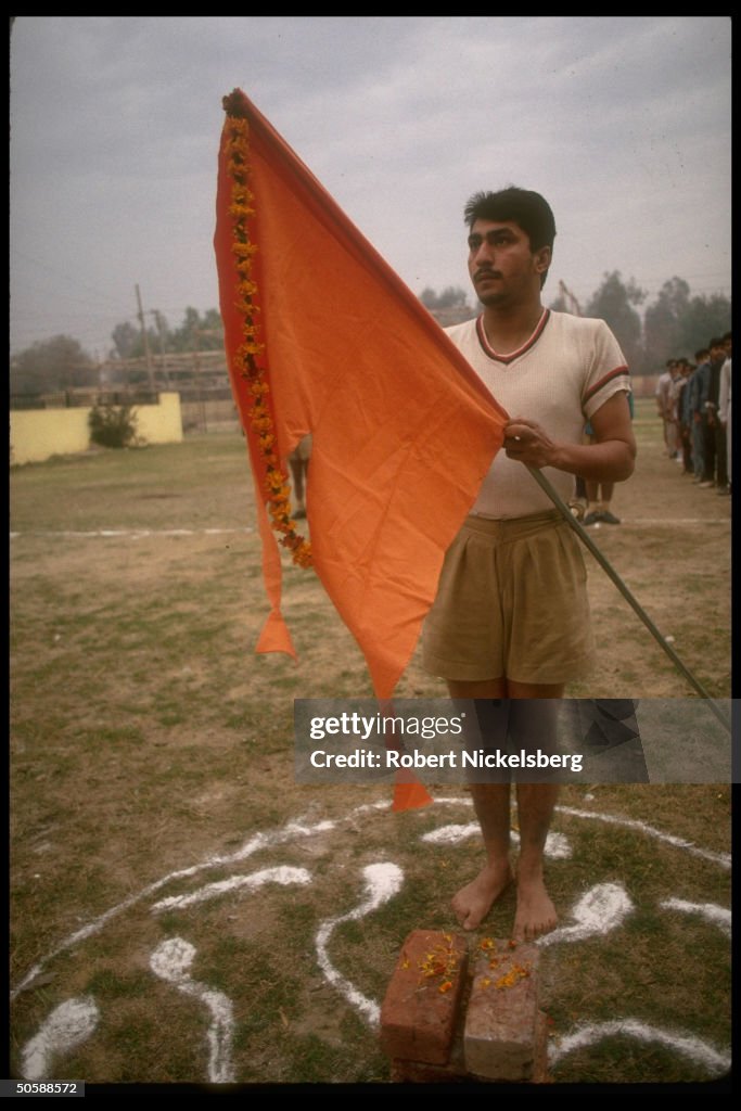 Flag holding youth during early AM physi