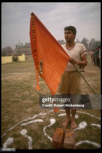 Flag holding youth during early AM physical training shaka of RSS, Rashtriya Swayamsevak Sangh, Hindu cultural org.