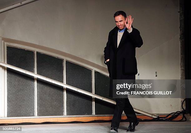 Belgian designer Raf Simons acknowledges the crowd at the end of his fashion show during the men's Fashion Week for the 2016-2017 Fall/Winter...