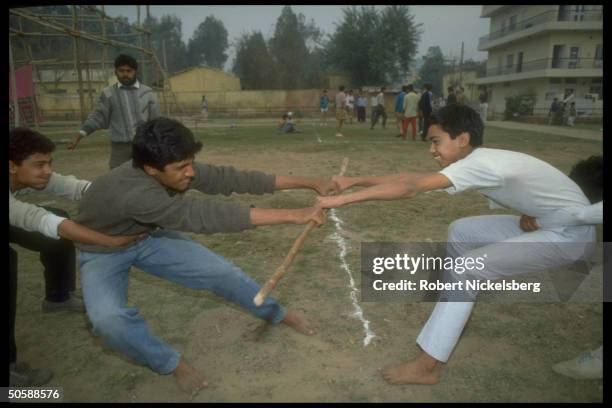 Stick fighting youths in tug of war exercise during physical training shaka of RSS, Rashtriya Swayamsevak Sangh, Hindu cultural org.