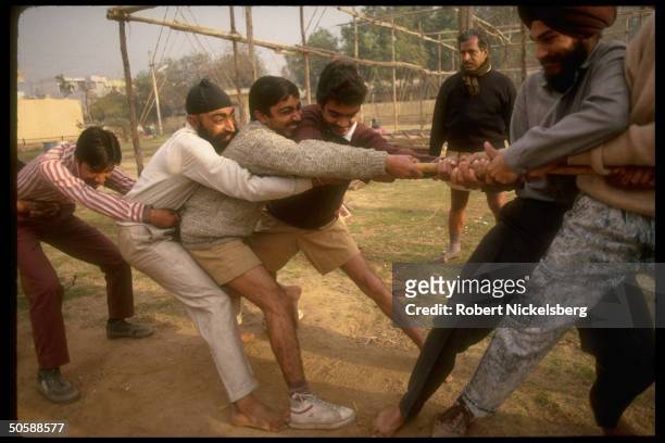 Stick fighting youths in tug of war exercise during physical training shaka of RSS, Rashtriya Swayamsevak Sangh, Hindu cultural org.