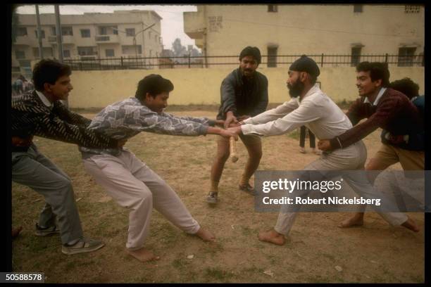 Stick fighting youths in tug of war exercise during physical training shaka of RSS, Rashtriya Swayamsevak Sangh, Hindu cultural org.