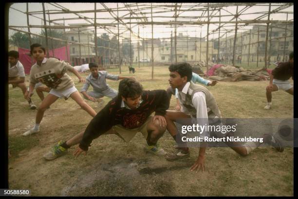 Youths during wrestling type exercise, in early AM physical training shaka of RSS, Rashtriya Swayamsevak Sangh, Hindu cultural org.