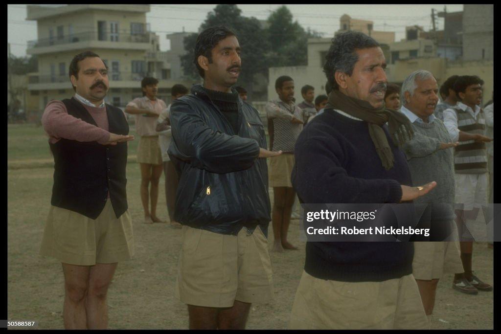 Men performing exercise drill, in early