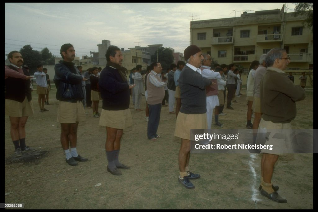 Men performing exercise drill, in early