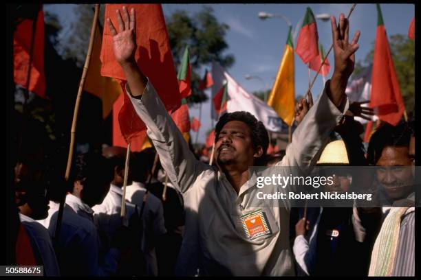 Emoting Hindu nationalist Bharatiya Janata supporter amid BJP banner & flag-waving crowd during party convention fete in Jaipur, Rajasthan state,...