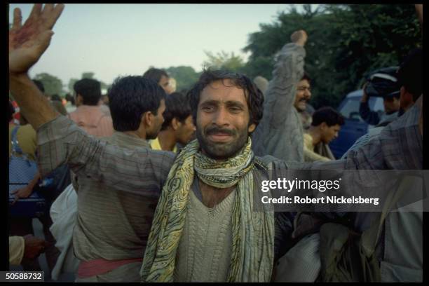 Emoting multitude of militant Hindu activists rioting, re razing Muslim mosque, Babri Masjid, & erecting Hindu temple to god-king Rama.