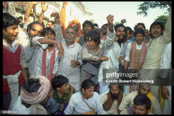Emoting multitude of militant Hindu activists rioting, re razing Muslim mosque, Babri Masjid, & erecting Hindu temple to god-king Rama.