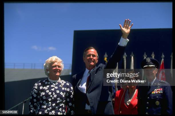 Waving Pres. & Barbara Bush w. Gen. & Mrs Charles Hamm , during Air Force Academy Falcon Stadium graduation fete.