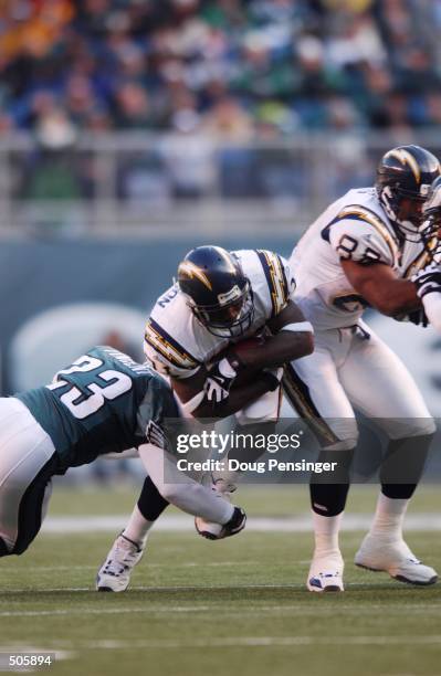 LaDainian Tomlinson of the San Diego Chargers breaks through the defense of Troy Vincent of the Philadelphia Eagles during the game at Veterans...