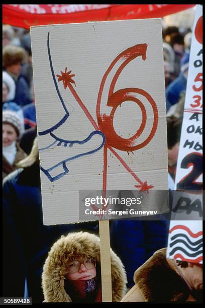 Boot-kicking 6 sign held by pro-democracy demonstrators protesting Article 6 legislating dominance of Communist Party.