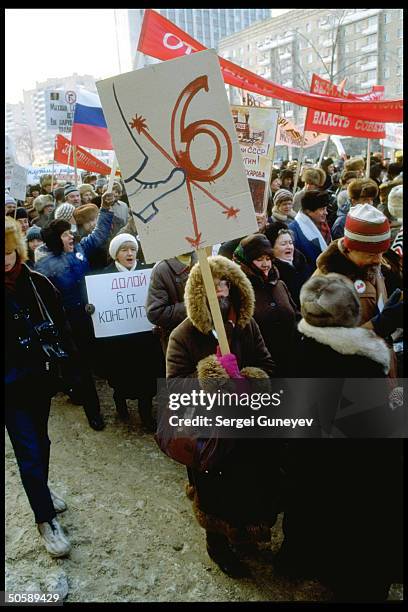 Boot-kicking 6 sign held by pro-democracy demonstrators protesting Article 6 legislating dominance of Communist Party.