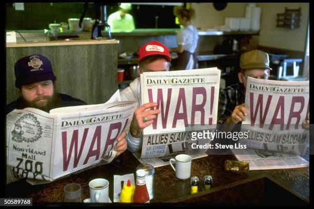 Men reading local DAILY GAZETTE newspaper w. Headline: WAR!, at Friendship House restaurant, on morning after Operation Desert Storm began.