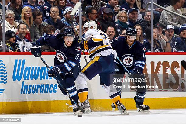 Matt Halischuk of the Winnipeg Jets watches as teammate Andrew Copp plays the puck away from Eric Nystrom of the Nashville Predators during second...