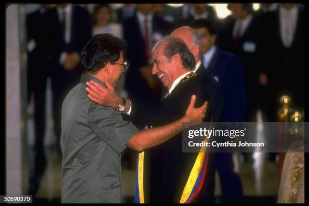 Inaugural-sashed Pres. Carlos Andres Perez warming embracing Nicaraguan Pres. Daniel Ortega, among heads-of-state attending taking-of-office fete.