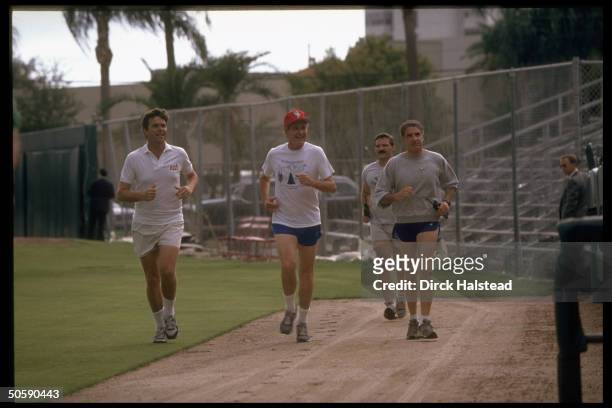 Pres. Bush out on (his read my hips jog, running w. His son Jeb & secret servicemen, at St. Petersburg Stadium.