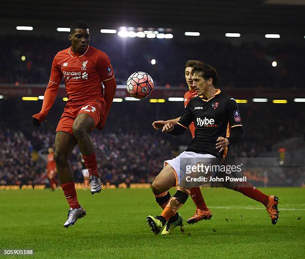 Sheyi Ojo of Liverpool competes with Craig Woodman of Exeter City during The Emirates FA Cup Third Round Replay between Liverpool and Exeter City at...