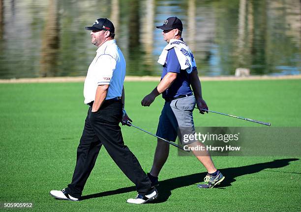 Jason Gore makes his way to the ninth green with his caddie during preview for the CarerrBuilder Challenge In Partnersihip With The Clinton...