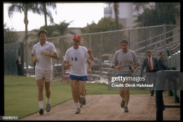 Pres. Bush out on (his read my hips jog, running w. His son Jeb & secret servicemen, at St. Petersburg Stadium.